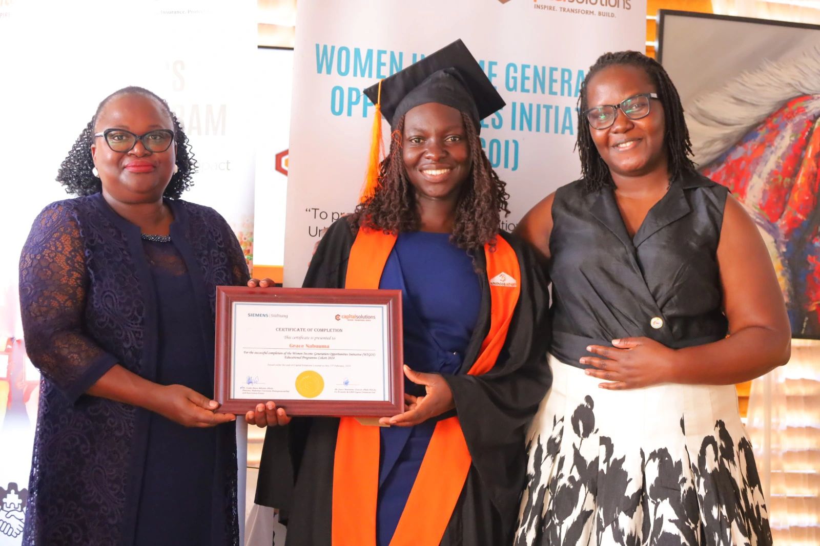 Nabuuma Grace receiving a Certificate.